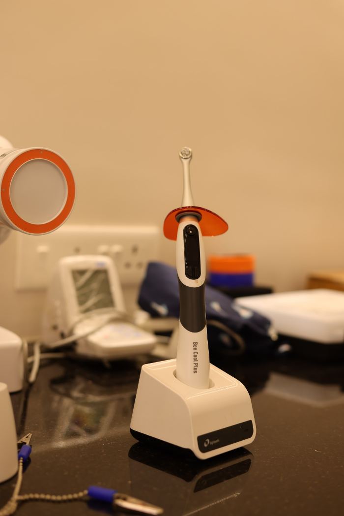 LED curing light on its charging stand